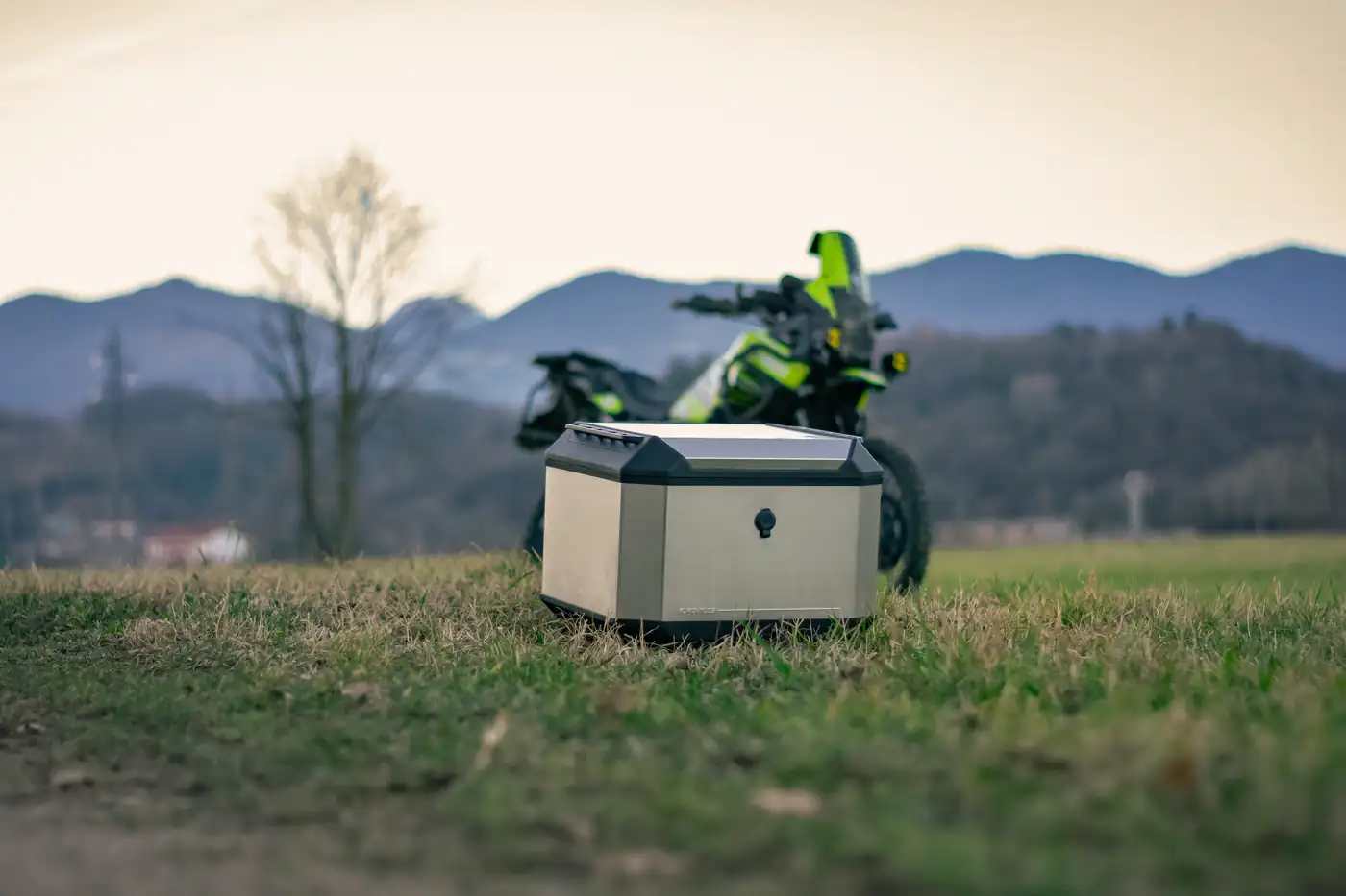 Motocicleta con maleta lateral en campo abierto